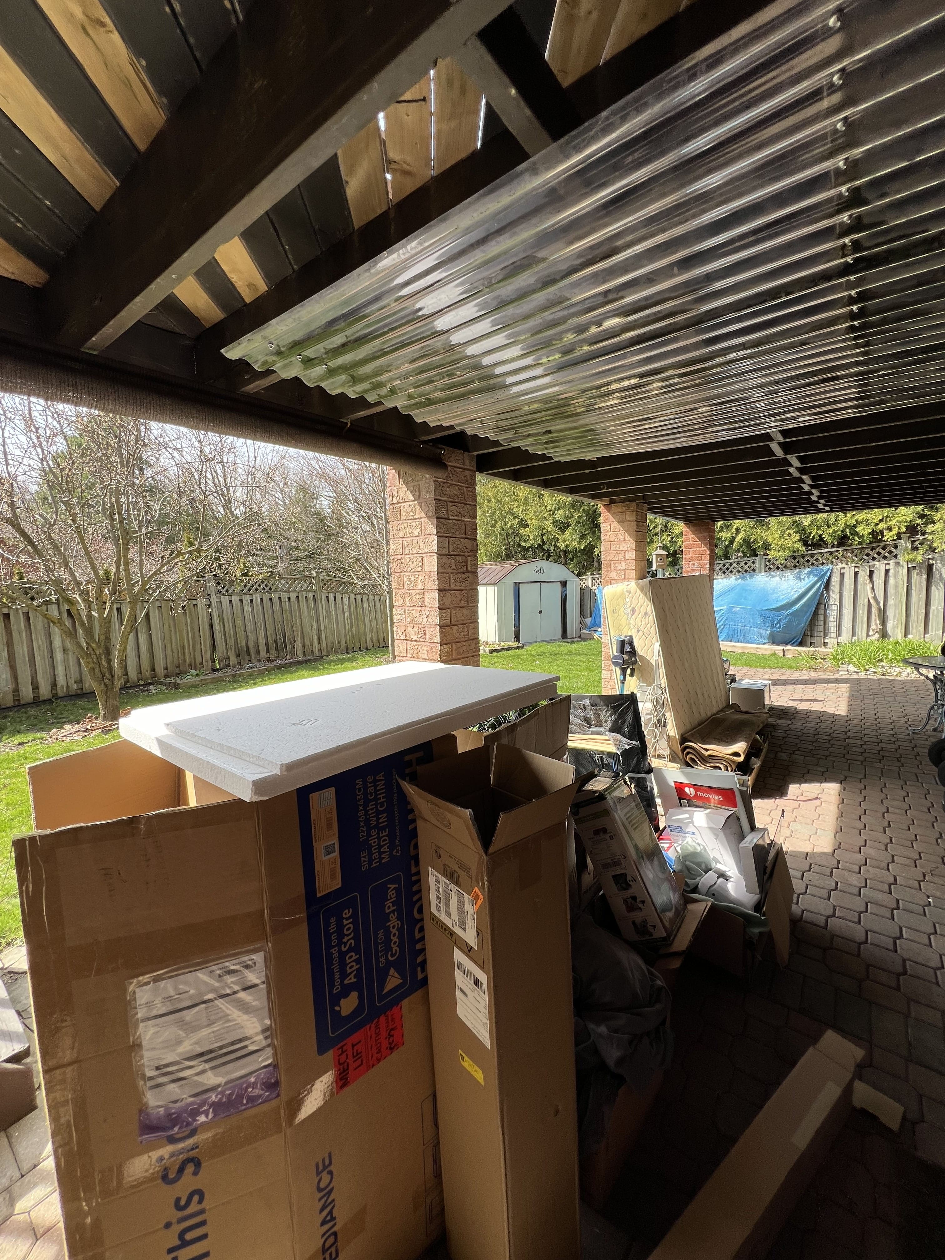 Cluttered backyard patio before junk removal